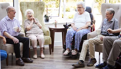 A group of seniors having a great time in a retirement home