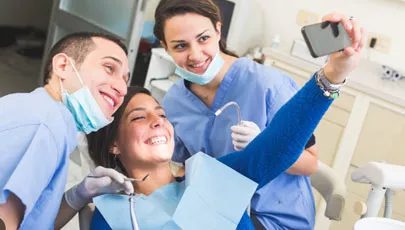 Customer takes selfie with Cosmetic Dentists - very happy