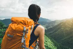 A woman backpacking in the hills